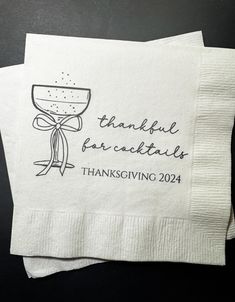 two napkins with the words, thank for cocktails and a wine glass on them