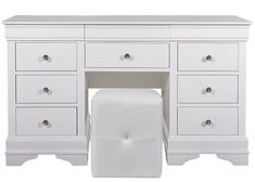 a white vanity with drawers and a toilet paper dispenser