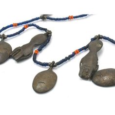 Naga Ancestor Necklace with 19th Century Bronze Heads and Figures Framing this magnificent Naga Ancestor/ "Head Hunter's" Bronze Charm Collection are Hand-wound Naga Heirloom Glass Beads, originally created in the late 19th century up until the mid 20th century in China, and made to resemble precious red coral, turquoise, lapis lazuli and golden amber. These richly colored beads were later traded among Naga people in Northern India and Burma. Because of their rarity and desirability, these "fore Vintage Ceremonial Jewelry With Polished Beads, Artisan Hand-strung Jewelry For Ceremonial Occasions, Antique Beaded Pendant Necklace, Ceremonial Beaded Pendant Jewelry, Antique Beaded Pendant Jewelry, Head Hunter, Hand Wound, Brass Pendants, Golden Amber