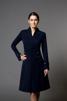 "A beautiful structured dress featuring high neck collar, a-line silhouette, and long sleeves. - high neck (stand collar) - trapeze skirt with inverted front pleat - long sleeves with elegant cuffs - knee length (midi) - a line silhouette - the dress is decorated with high-quality metal buttons Perfect as party, modest bridesmaid or elegant office dress. Seasons: autumn, winter, spring. Color: Blue / Black / Mustard / Burgundy / Grey Fiber: viscose - 60%, elastan - 5%, polyester - 35% Concealed Italian Costume, Stile Casual Chic, Beautiful Cocktail Dresses, Dresses For Wedding Guest, Structured Dress, Marine Uniform, Dark Blue Dress, Office Dresses For Women, Long Sleeve Cocktail Dress