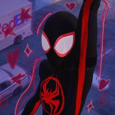 a spider - man doll is standing in front of a window with hearts on it