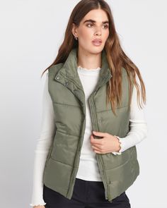 Cozy up in a lightweight layer that delivers next-level warmth and style. Crafted with a soft down taffeta shell and polyester insulation, this green vest provides reliable warmth without bulk. The high neck, quilted design, and handy welt pockets make it a versatile layer for any cold-weather adventure. -   - Shell: 100% Soft Down Taffeta, 35GSM,  - Lining: 100% Polyester Brushed Tricot, 210GSM  - Fill: 100% Polyester rolled insulation, 190GSM  - Zip front, high neck vest with quilting  - Storm Olive Green Puffer Vest Outfit, Snow Surfing, Green Vest, Puffer Vest, Style Board, Welt Pockets, Quilting Designs, Welt Pocket, Army Green