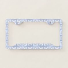 a blue and white license plate frame on a gray background with an intricate design in the middle