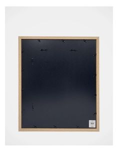 an empty wooden frame on the wall with screws and holes in it for display