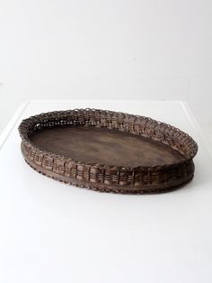 a brown wicker tray sitting on top of a white table