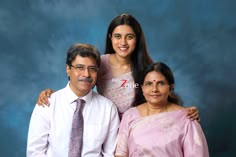 two women and a man posing for a photo