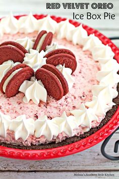 a red velvet oreo ice box pie with white frosting and cookies on top