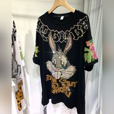 Flashy Bling T-Shirt With Bunny & Floral Design. Multicolor Rhinestones. High Quality, Expert Craftsmanship. *One Size But Measures 22" Ptp, 30" Length. 95% Cotton, 5% Spandex. Retails For $49.95! Black Embellished Cotton T-shirt, Black Rhinestone T-shirt For Party, Black Rhinestone T-shirt For Streetwear, Casual Black Sequined T-shirt, Black T-shirt With Rhinestones For Party, Trendy Embellished Black Tops, Trendy Black Embellished Tops, Black Embellished T-shirt For Party, Black Sequin Short Sleeve T-shirt