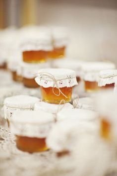 small jars filled with honey sitting on top of a table