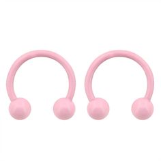 three pink balls are attached to the back of a pair of fake gauged earrings