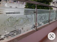 a glass railing with decorative designs on it