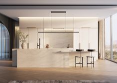 a modern kitchen with marble counter tops and bar stools in front of large windows