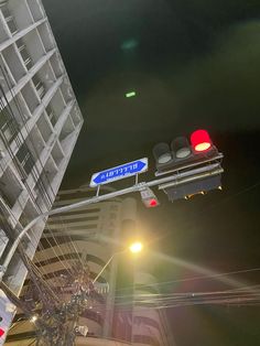 a traffic light hanging from the side of a tall building