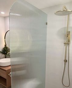 a bathroom with a shower head and sink in the corner next to a stand up shower