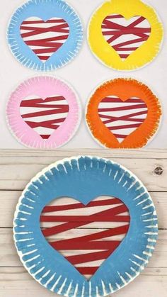 three paper plates with hearts painted on them