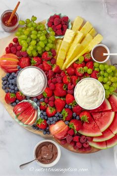 a platter with fruit and dips on it