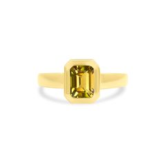 a yellow sapphire ring on a white background