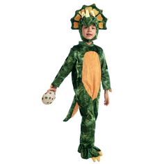 a little boy in a green dinosaur costume holding a soccer ball and wearing a glove