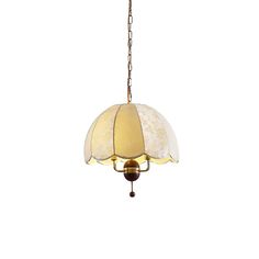 a light fixture hanging from a chain with a white shade on the top and bottom