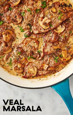 a pan filled with meat and mushrooms covered in sauce