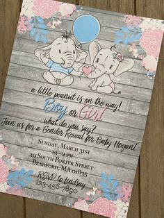 an elephant baby shower party with pink and blue flowers on the wood planked floor