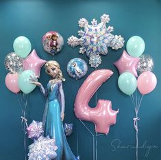 the frozen princess balloon wall is decorated with balloons and streamers for her 6th birthday