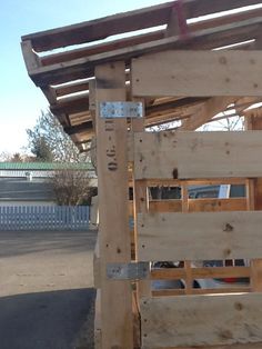 a wooden structure that is being built in the yard with wood slats on it