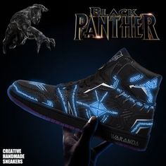 a black panther shoe with blue lights on it