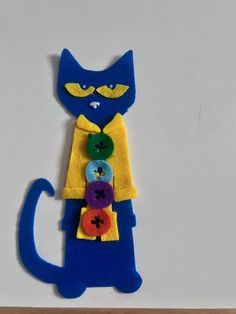 a cat made out of felt with buttons on it