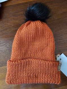 This beautiful pumpkin coloured double thickness bobble hat will keep your head nice and warm over the colder months. The hat has a black faux fur bobble that is in place by a button at the crown on the inside. This means you can remove the bobble before washing.  Once your hat is lovely and clean, you can install the hat by using a hook from the inside to pull the elastic loop through the hat and put the bobble back in place. This hat is 100% acrylic. Please wash on a gentle cycle, and dry on a very cool drying cycle. Please do not iron or use chemicals at a dry cleaners. Double Pompon Hat, Crochet Chocolate Orange Bobble Hat, Beautiful Pumpkins, Bobble Hat, Pumpkin Colors, Bobble Hats, Handmade Hat, Dry Cleaners, Black Faux Fur