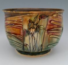 a ceramic bowl with flowers painted on it