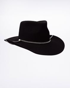 The Black Cowboy Hat is inspired by the black granite stone that is to be found in the Swedish mountains. Like the stone, the color of the hat is characterised by its' deep black shade that shifts minimally in contrasting lights and environments. The unisex hat is shaped similarly to the classic cowboy hat with a dynamic brim. It comes with a handmade chunky chain in stainless steel and a cream white pearl that symbolises the magical force of the Scandinavian moon light. Swedish Mountains, Black Cowboy Hat, Classic Cowboy, Contrast Lighting, Black Cowboy, Moon Light, Granite Stone, Black Granite, Black Shade