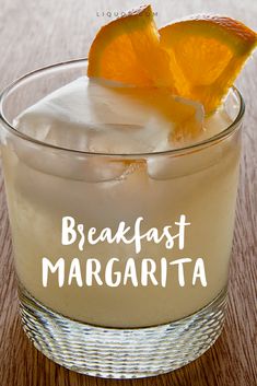 an orange slice sitting on top of a drink in a glass with the words breakfast margarita