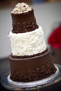 three tiered cake with white and chocolate frosting