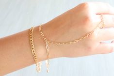 Double gold chain bracelet with attached gold ring Chic Jewelry With Chain Strap For Gift, Gold Plated Chain Link Ring, Elegant Everyday Gold Chain Ring, Elegant Chain Link Bracelet With Chain Strap, Everyday Jewelry With Chain Link Strap, Gold-tone Oval Link Double Chain Jewelry, Trendy Delicate Link Chain Bracelet, Minimalist Everyday Jewelry With Chain Strap, Trendy Chain Strap Jewelry As Gift