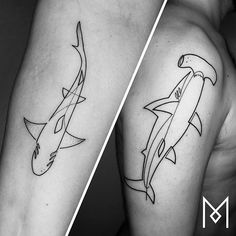 two different tattoos on the arms of men, one with a shark and another with a fish