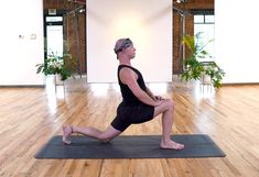 a man is doing yoga in an empty room