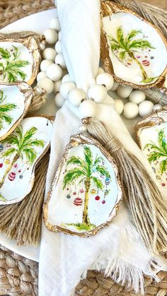 decorated cookies with palm trees on them are sitting on a wicker basket next to white beads