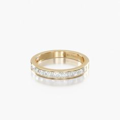 a yellow gold wedding band with channeled diamonds