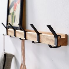 three hooks are attached to a coat rack