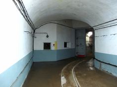 an empty tunnel with blue and white walls