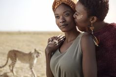 two women standing next to each other in the desert