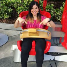 a woman sitting in a red and yellow chair