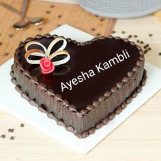 a heart shaped chocolate cake with the words happy anniversary on it