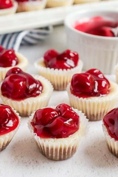 small cupcakes with red jelly on them are ready to be eaten and served