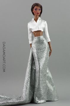 a barbie doll wearing a white shirt and silver skirt