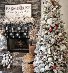 a decorated christmas tree in front of a fireplace