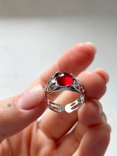 This adjustable ring with precious garnet stone is suitable for the brightest and boldest. Easily add brightness to your style. It is suitable both for every day and for any holiday - you definitely will not go unnoticed🥂 This ring can be mixed with other jewelry depending on the mood. This versatile, but at the same time unique jewelry is suitable both for a gift and to please yourself - you definitely will not go wrong with the size and choice, as this ring can be easily adjusted to the size Round Garnet Jewelry For Promise, Round Garnet Promise Jewelry, Ruby Open Promise Ring, Garnet Birthstone Open Ring, Adjustable Ruby Ring For Promise, Adjustable Round Garnet Ring, Garnet Solitaire Jewelry Gift, Round Cabochon Garnet Jewelry, Garnet Solitaire Jewelry As Gift