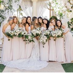 a group of women standing next to each other in front of a white gazebo