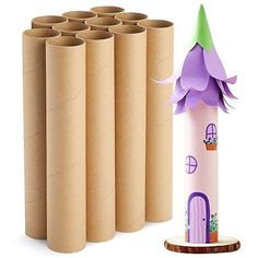 a group of toilet paper rolls next to a tower with a purple flower on top